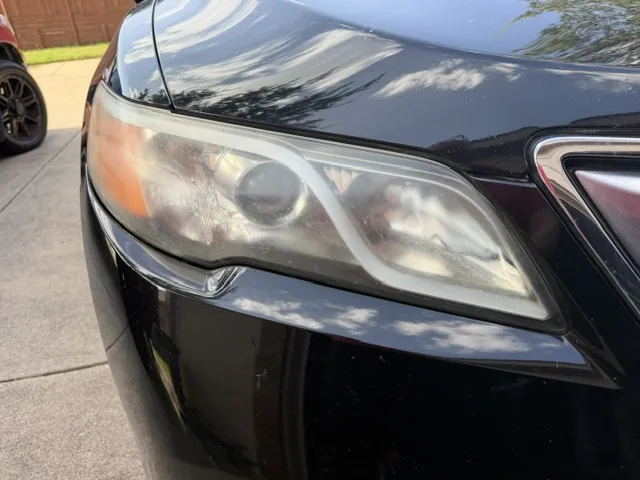 Cloudy Acura headlight before restoration